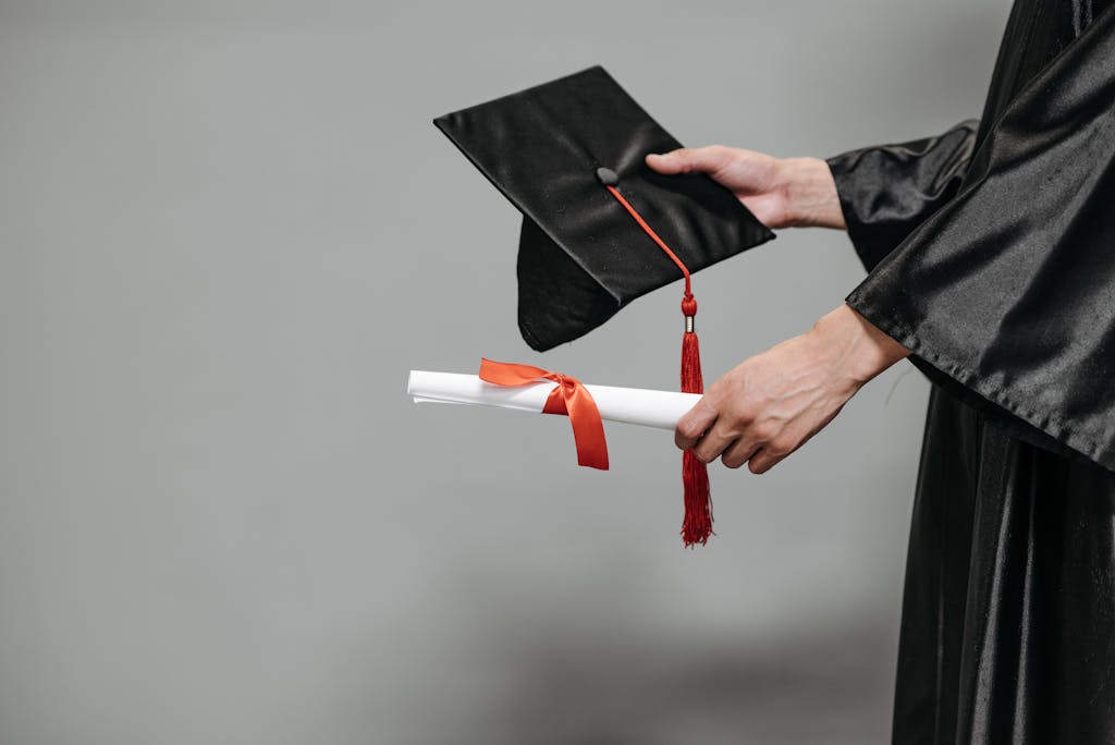 International graduate holding a cap and diploma, symbolising the transition from student visa to work visa in the UK.